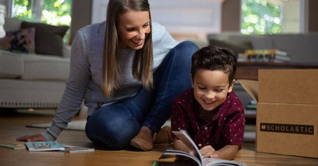 Parent and child reading a book.
