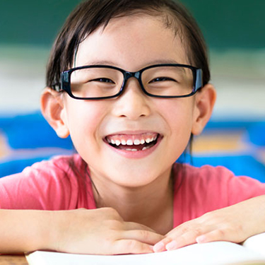 Girl sitting at desk reading a book